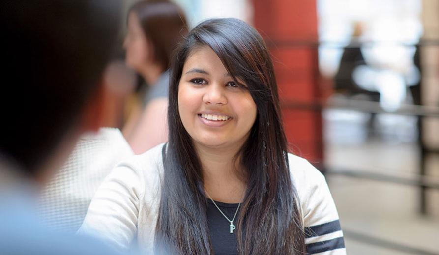 Woman smiling while facing another person who is out of shot. Woman smiling while facing another person who is out of shot.