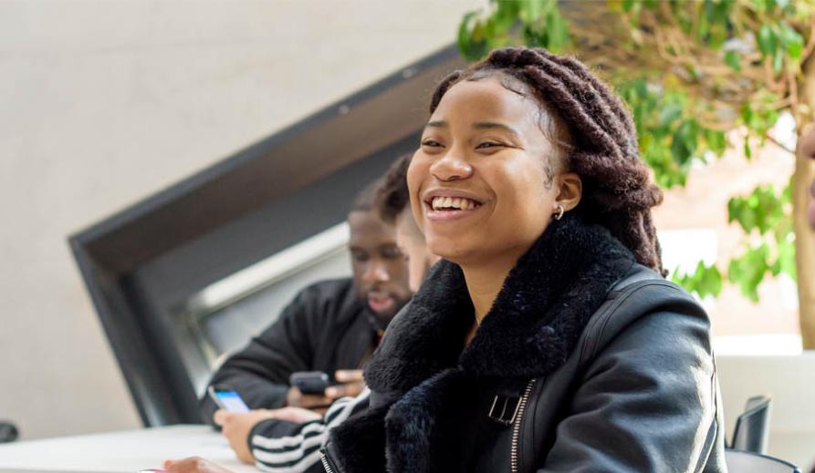 female student smiling with colleague female student smiling with colleague